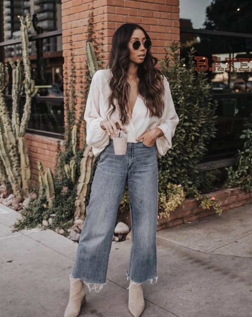 Woman wearing wide-legged jeans with a boho blouse 