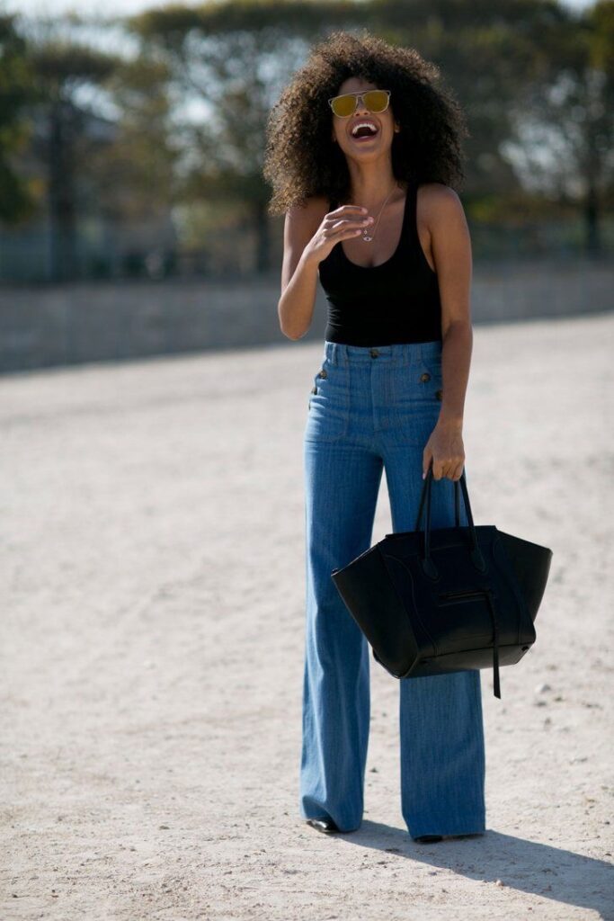 Woman wearing wide-legged jeans with a black tank
