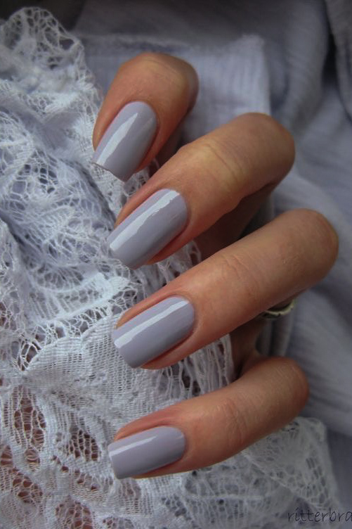 woman's hand with moody gray manicure