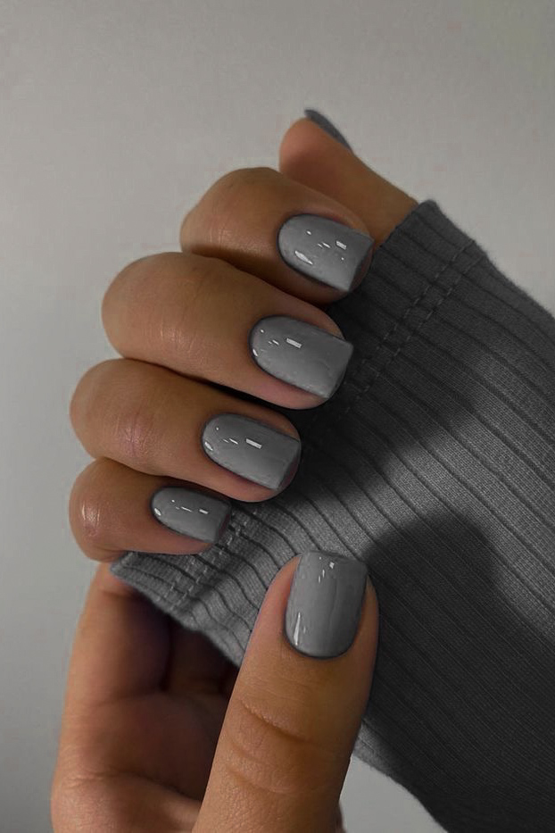 woman's hand with moody gray manicure