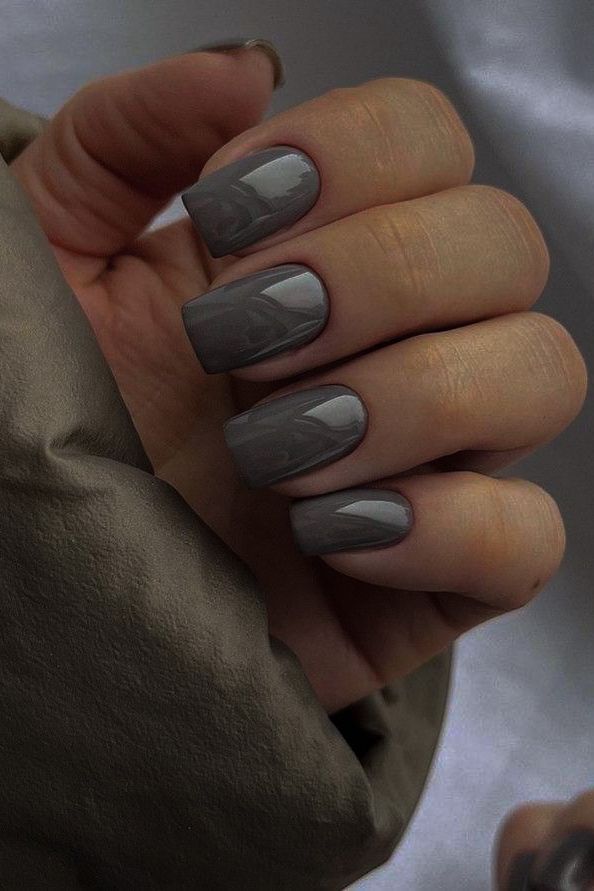 woman's hand with moody gray manicure