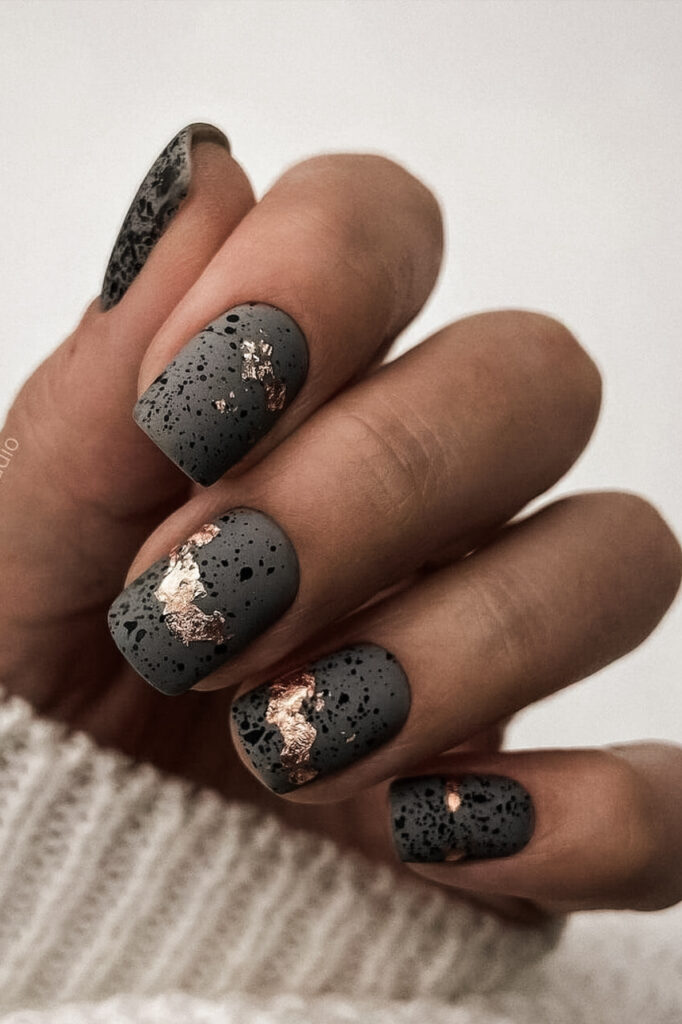 woman's hand with moody gray manicure