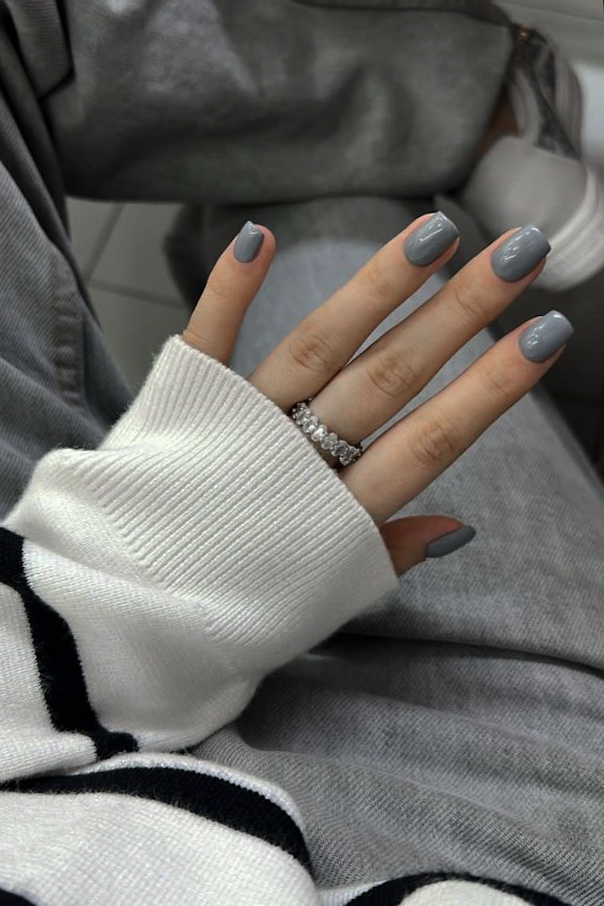 woman's hand with moody gray manicure