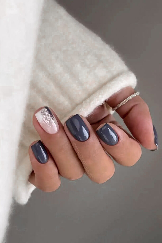 woman's hand with moody gray manicure