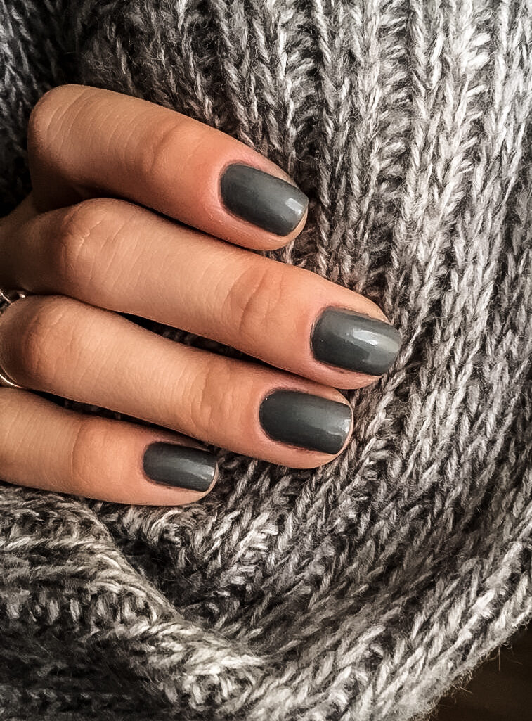 woman's hand with moody gray manicure