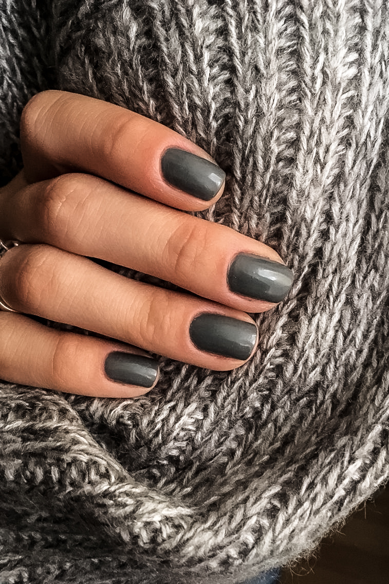 woman's hand with moody gray manicure