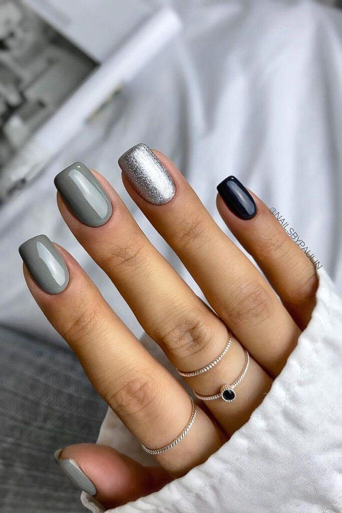 woman's hand with moody gray manicure