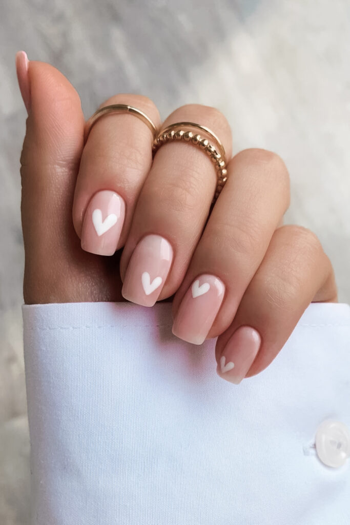 Neutral nail with tiny heart design for Valentine's Day