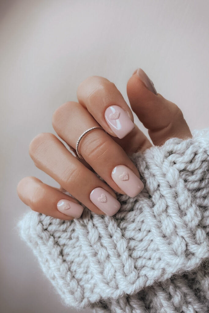 Neutral nail with tiny heart design for Valentine's Day