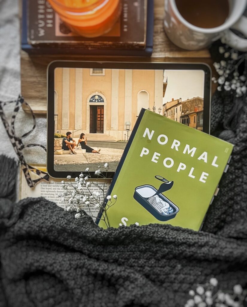 flatlay picture of Sally Rooney's Normal people book with the Hulu adaptation playing