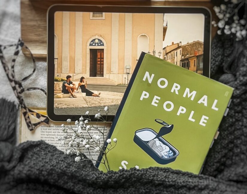 flatlay picture of Sally Rooney's Normal people book with the Hulu adaptation playing