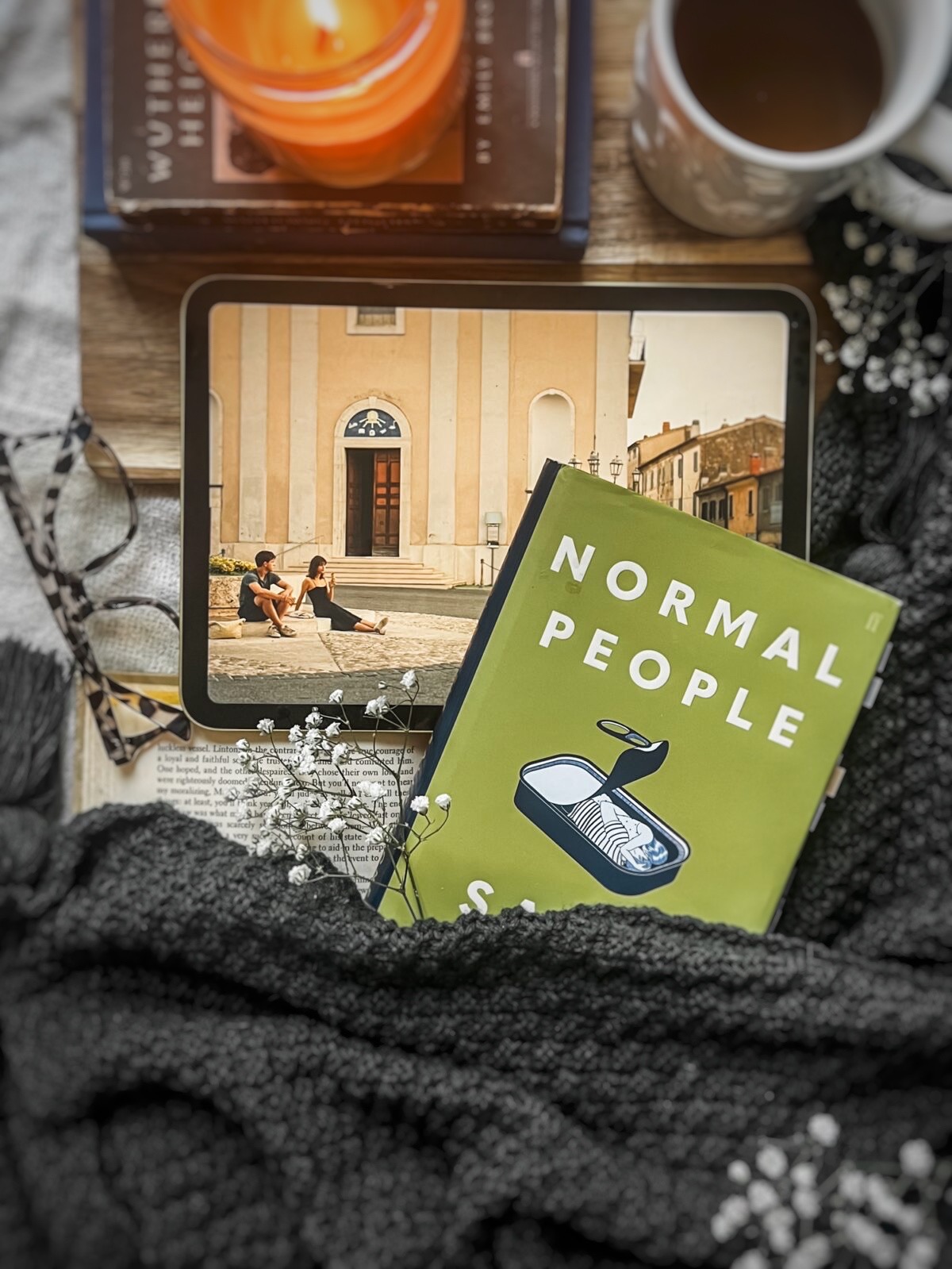 flatlay picture of Sally Rooney's Normal people book with the Hulu adaptation playing