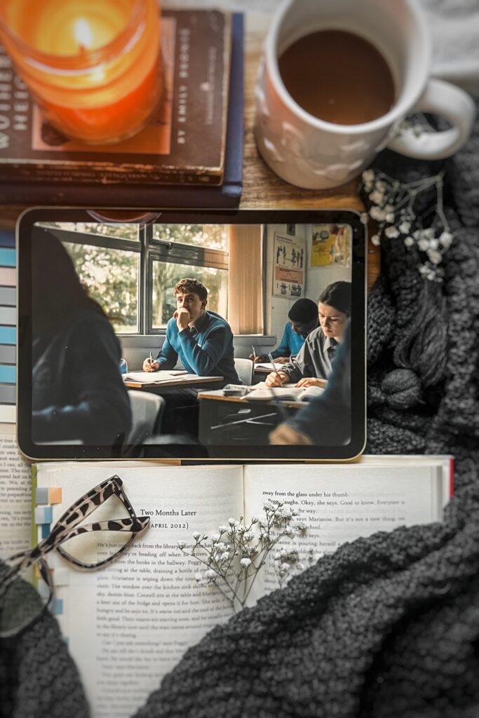 flatlay picture of Sally Rooney's Normal people book with the Hulu adaptation playing