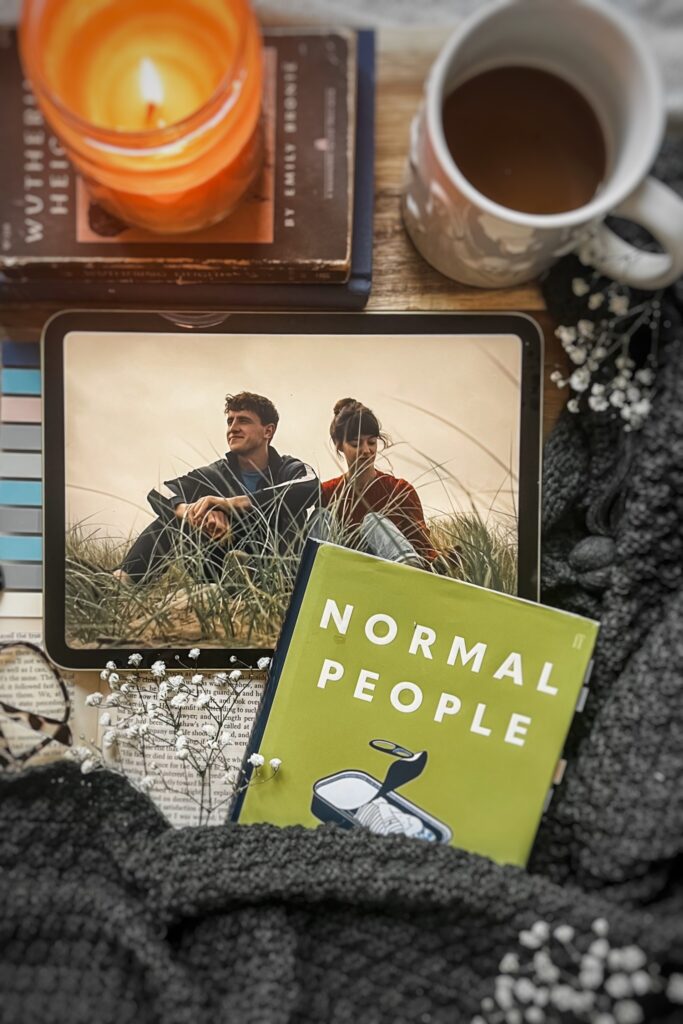 flatlay picture of Sally Rooney's Normal people book with the Hulu adaptation playing