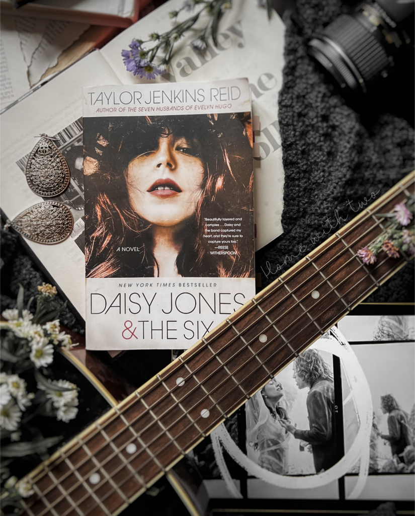 book flatlay of the book cover of Daisy Jones and the Six and Daisy with Billy from the Amazon series Daisy Jones and the Six